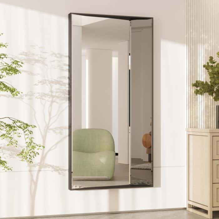 Luxurious full-length wall mirror with a sleek wooden frame, available in black with black-tinted mirror paneling and gold with rose-gold tinted mirror. Featuring a unique half-and-half design with precision beveled edges and an inward angle for a layered effect, this designer mirror adds depth and elegance to modern and classic interiors alike. Ideal for entryways, living rooms, and bedrooms as a functional art piece.