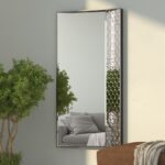 legant full-length wall mirror with sleek wooden frame and unique geometric detailing, featuring a section of intricately textured mirrored panels along one side, adding a modern design element. Ideal for enhancing luxury interior spaces, this mirror provides a balanced blend of style and functionality, reflecting natural light to create depth in any room