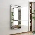 Large wall mirror with black and rose gold wooden frame featuring distinctive handcrafted prism-shaped paneling, creating a 3D effect. Ideal for enhancing luxury decor in living rooms