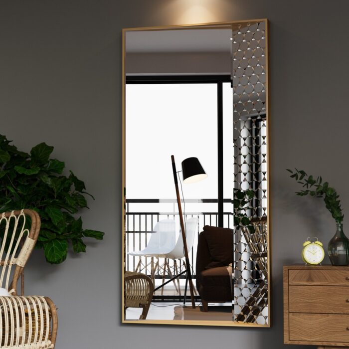 Elegant decorative wall mirror with geometric accents, framed in a sleek, modern gold border. The mirror is placed in a cozy, minimalist room with a wicker chair, lush green plant, and wooden dresser, offering a chic yet comfortable ambiance. Perfect for enhancing natural light and creating a spacious feel in the living area