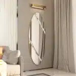 Modern oval wall mirror with durable wooden backing and gold edge detailing