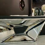 Sleek and reflective stainless steel furniture for entryways