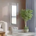 Free-standing full-length mirror with a beveled-edge glass panel, supported by a square cube base adorned with 3D prism-shaped mirrored artwork, perfect for contemporary interiors.