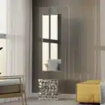 Free-standing full-length mirror with a beveled-edge glass panel, supported by a square cube base adorned with 3D prism-shaped mirrored artwork, perfect for contemporary interiors.