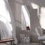 Free-standing full-length mirror with a beveled-edge glass panel, supported by a square cube base adorned with 3D prism-shaped mirrored artwork, perfect for contemporary interiors.