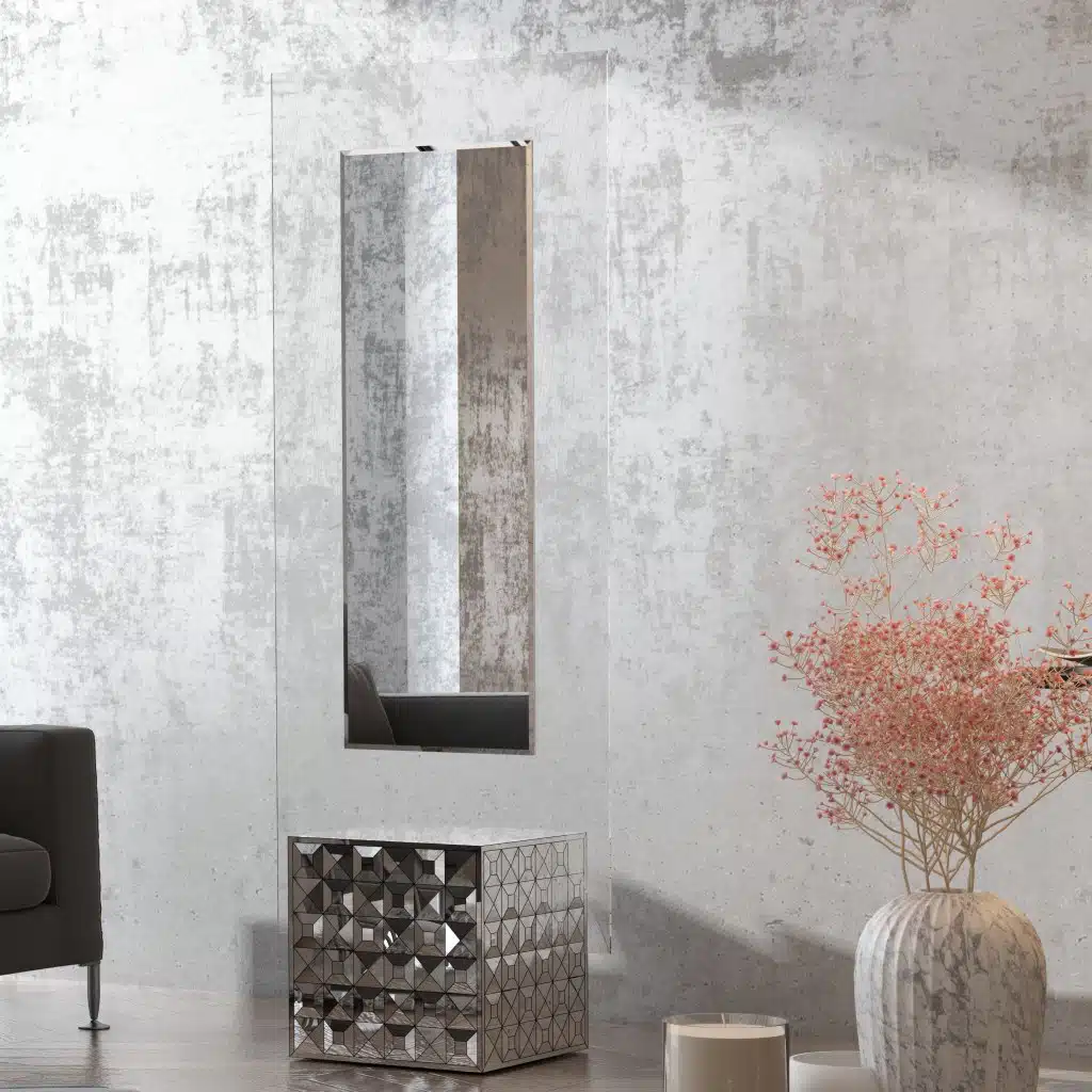 Free-standing full-length mirror with a beveled-edge glass panel, supported by a square cube base adorned with 3D prism-shaped mirrored artwork, perfect for contemporary interiors.