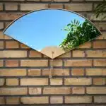 Handmade fan-shaped modern wall mirror set with bevelled glass and curved wood frame, inspired by Japanese design – decorative home wall art