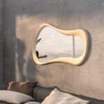 Freeform water droplet wall mirror in semi-matt gold finish