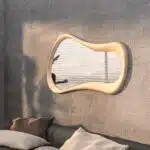 Freeform water droplet wall mirror in semi-matt gold finish