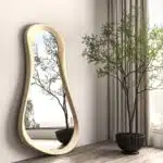 Freeform water droplet wall mirror in semi-matt gold finish