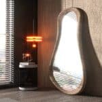 Pebble shaped modern wall mirror in natural beech finish