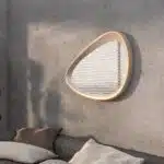 Freeform pebble mirror with semi-matt gold frame