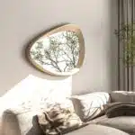 Freeform pebble mirror with semi-matt gold frame