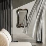 • Modern organic wall mirror in Ebony finish