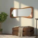 Organic shaped wall mirror in Pine finish