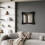 Handmade sculptural wall mirror in matt black paint