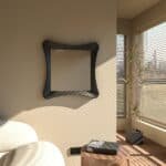 Handmade sculptural wall mirror in matt black paint