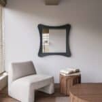 Handmade sculptural wall mirror in matt black paint