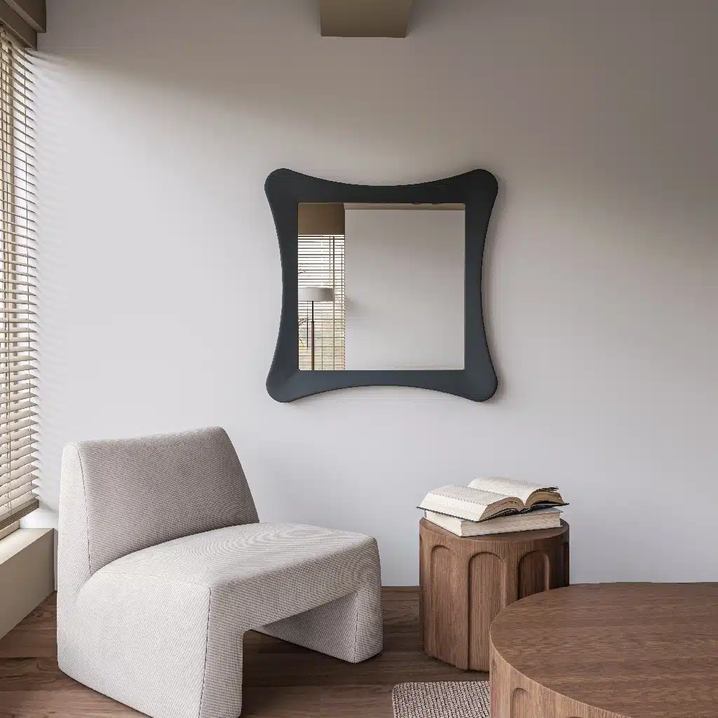 Handmade sculptural wall mirror in matt black paint